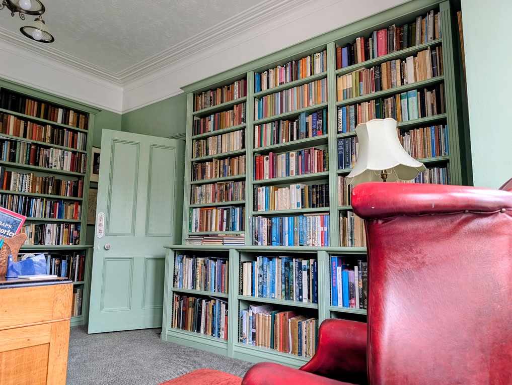 Bespoke painted home library with fitted bookcases handcrafted for a Victorian property in coastal Devon