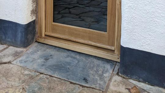 Bespoke air-dried oak glazed rear door with traditional oiled finish installed in a listed farmhouse.