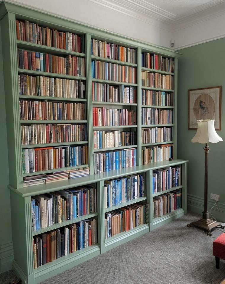 Built-in painted bookcase finished in Little Greene Pea Green 91 with adjustable shelving.