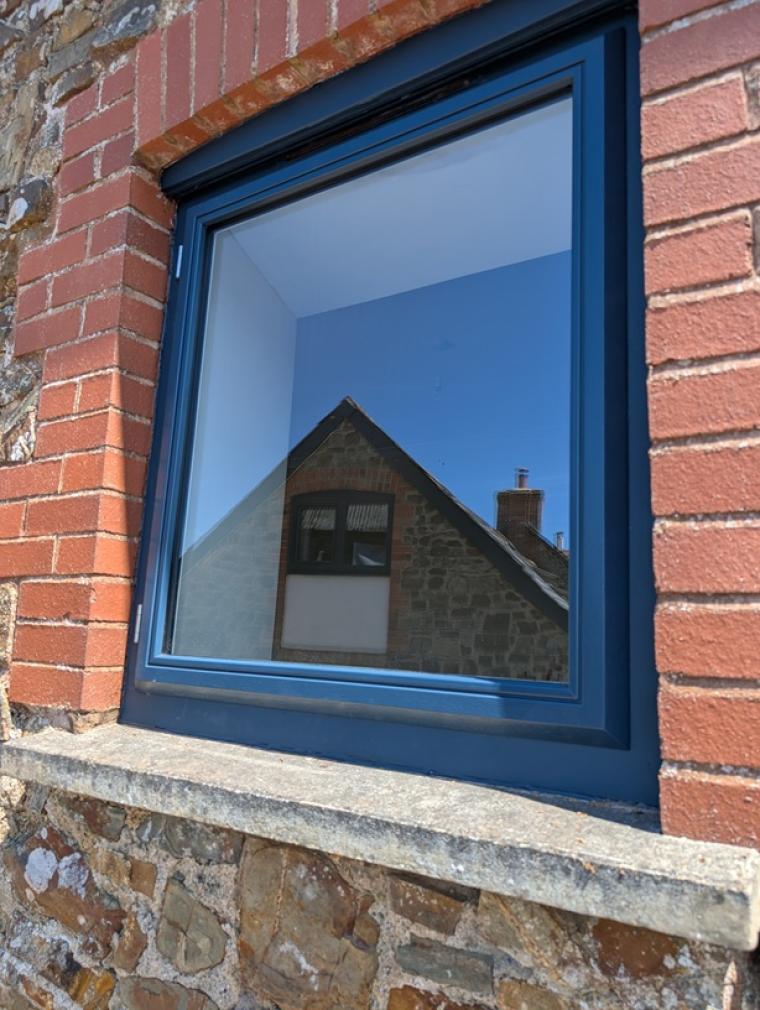 Upgraded hardwood casement window with the central mullion removed to create larger glazed areas, improved views and increased natural light.