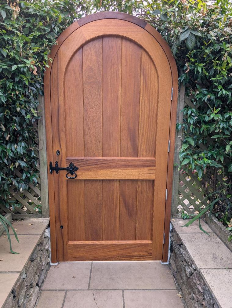 Bespoke Iroko gate and timber arbour forming the garden entrance