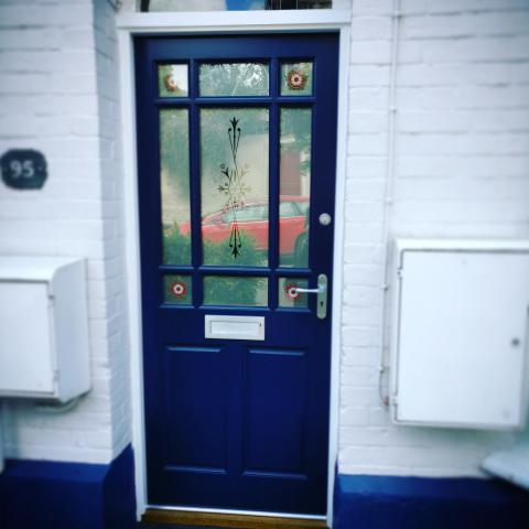Blue front door with stained effect glazing