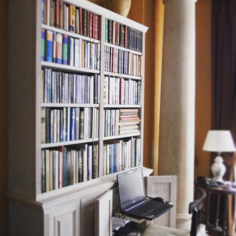 Hand made oak wood bookcase in a library made in Devon