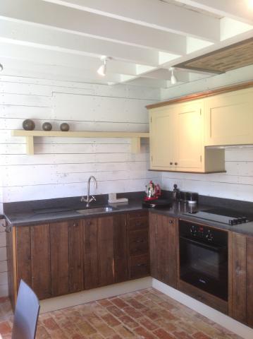 Fitted custom wood kitchen with wooden floor boards