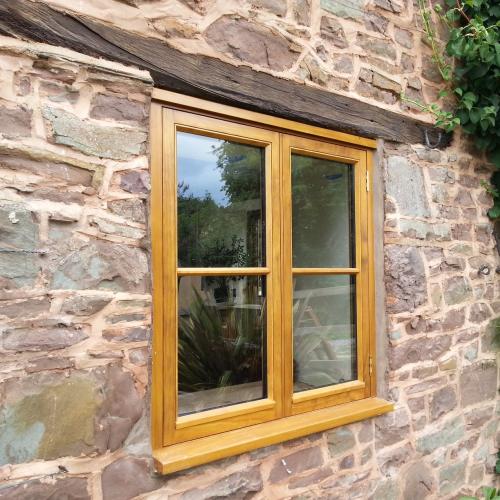 solid wooden window on stone built house